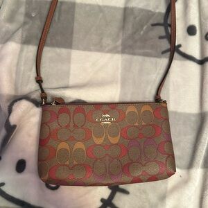 Red,purple, and brown leather Coach crossbody bag